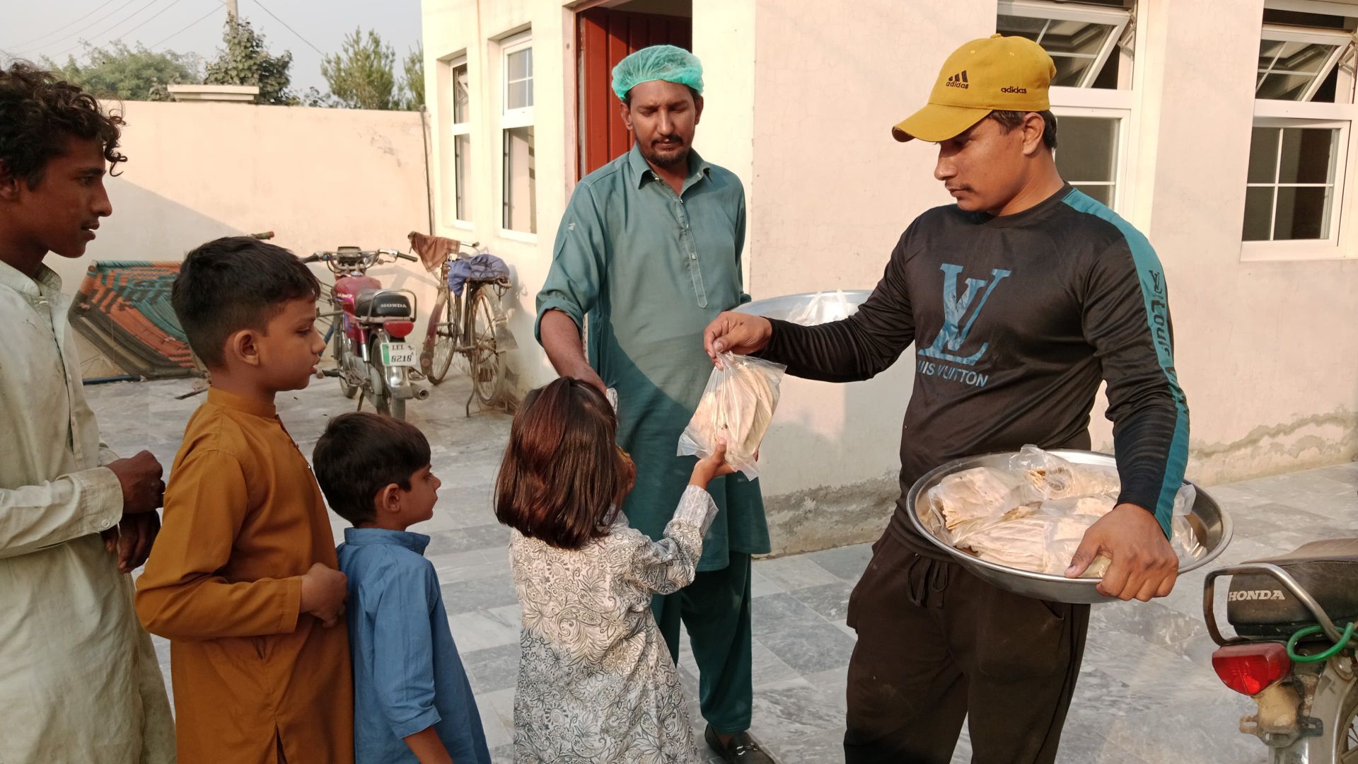 Volunteers distributing food to children in a community
